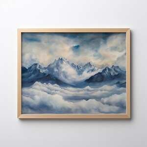 May include: A framed painting depicting a mountain range with snow-capped peaks, partially obscured by clouds. The sky is a light blue with white clouds. The mountains are a dark blue and the clouds are white.