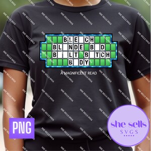 May include: A black t-shirt with a green and blue game show board design. The board has the letters "BLECH BLNDEBD BLTB TCH BDY" on it. The text "A MAGNIFICENT READ" is below the board.