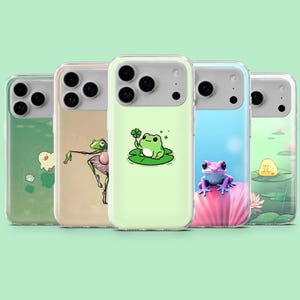 Pode incluir: Cinco capas de telefone com ilustrações de sapos. Os designs incluem um sapo com um trevo de quatro folhas, um sapo bailarino e um sapo rosa em uma flor de lótus. As capas têm um design transparente e protetor.