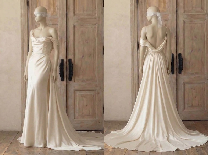 A mannequin wearing a long, off-the-shoulder white wedding dress with a flowing train, displayed in front of a wooden door.