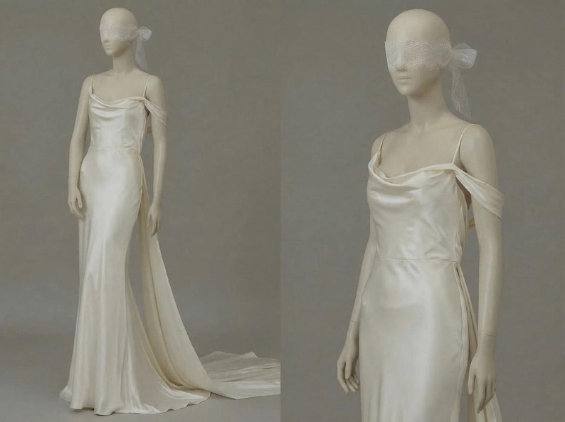 A mannequin wearing a long, off-the-shoulder white wedding dress with a flowing train.