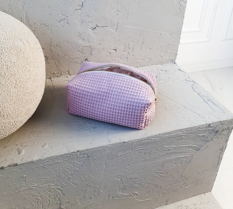 Handmade waffle-textured minimalist makeup bag with zipper, eco-friendly toiletry pouch in dusty rose  tones.