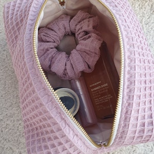 Interior view of the makeup bag, showcasing practical organization for cosmetics and toiletries.