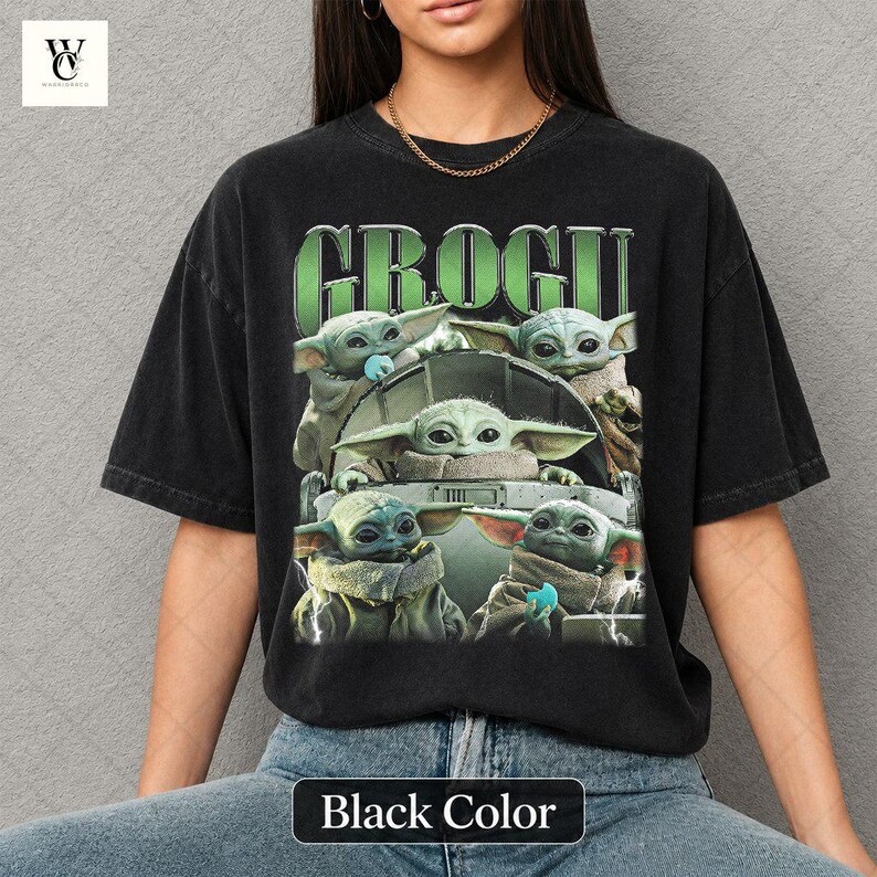 May include: Black t-shirt featuring a graphic of Grogu, also known as Baby Yoda, from The Mandalorian. The design includes multiple images of Grogu with the word "GROGU" in green block letters. The shirt is a dark color and has a vintage look.
