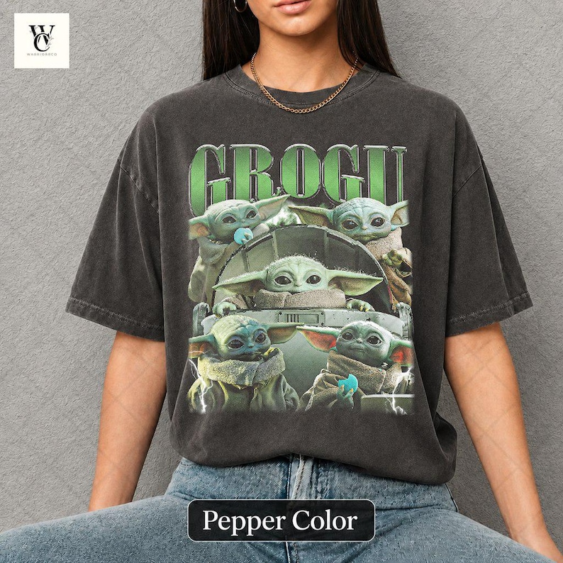 May include: Pepper color t-shirt featuring a graphic of Grogu from The Mandalorian. The design includes multiple images of Grogu, with the name "GROGU" in green block letters above. The shirt is a relaxed fit.
