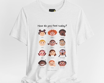 May include: A white t-shirt featuring the text How do you feel today? above a grid of twelve illustrated faces representing various emotions including calm, angry, sleepy, sad, happy, worried, shy, tired, shocked, proud, hurt, and afraid.
