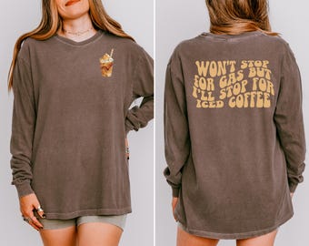 May include: Brown long-sleeve shirt with an iced coffee graphic on the front. The back of the shirt features the text "Won't Stop For Gas But I'll Stop For Iced Coffee" in a retro font. The shirt is a neutral colour.