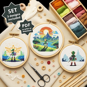 May include: A craft set featuring three cross-stitch designs in wooden hoops, with a video game theme. The image includes embroidery threads, scissors, and other craft supplies. The text on the image says "SET 3 designs included" and "PDF to print or download".