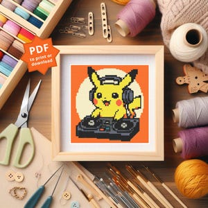 Könnte beinhalten: Kreuzstichmuster von Pikachu als DJ, in hellem Holz gerahmt. Das Bild zeigt ein gelbes Pikachu mit Kopfhörern und einem DJ-Setup vor orangefarbenem Hintergrund. Der Text "PDF to print or download" befindet sich in der oberen linken Ecke.