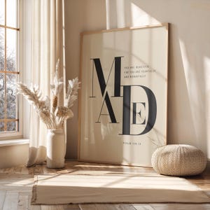 Oversized beige and black fearfully and wonderfully made Psalm 139:14 MADE typography poster in wooden frame leaning against sunlit wall with dried pampas grass, Christian scripture wall art digital download