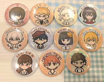 May include: A collection of eleven circular pin-back buttons featuring chibi-style anime character illustrations. Each button displays a unique character with their name printed in an arc above them, including Dazai Osamu, Kunikida Doppo, Atsushi Nakajima, Kyouka Izumi, Fukuzawa Yukichi, Ranpo Edogawa, Yosano Akiko, Kenji Miyazawa, Kirako Haruno, Junichiro Tanizaki, and Katai Tayama.