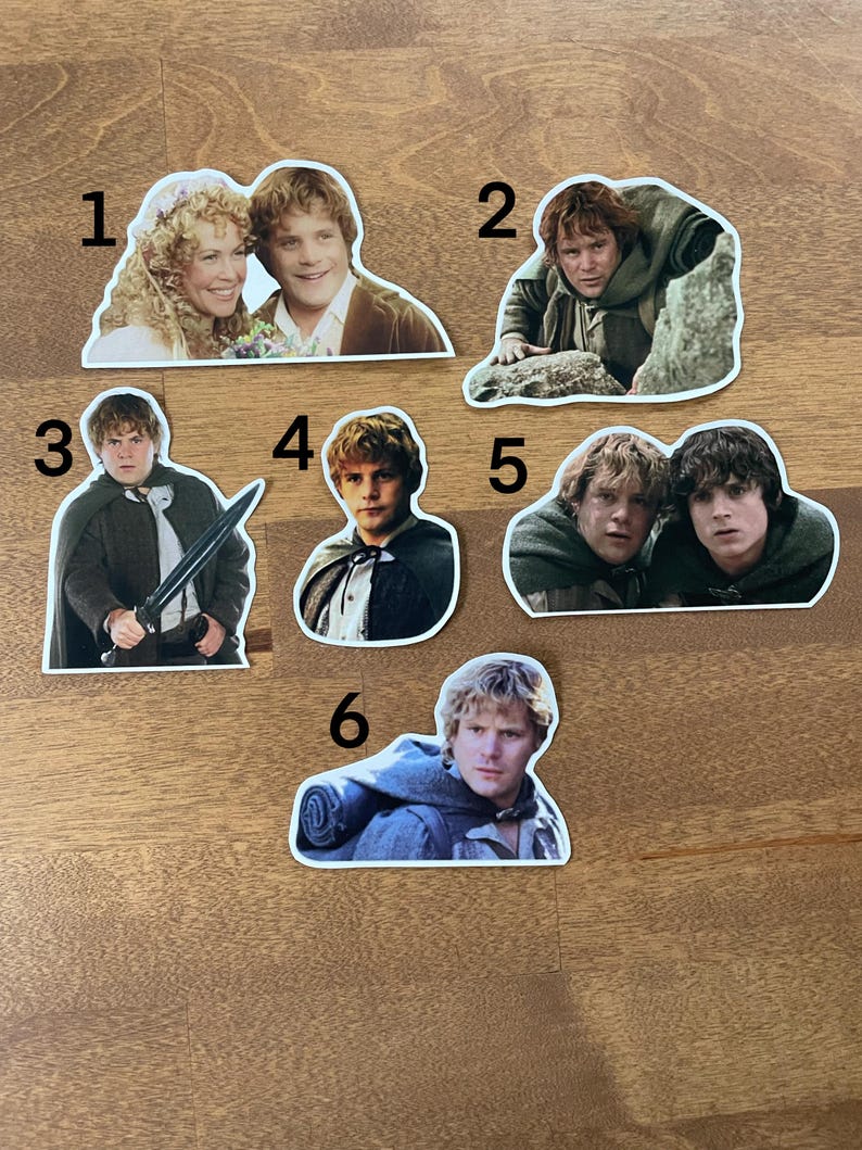 May include: Six different stickers featuring characters from the Lord of the Rings movie franchise. The stickers are printed on white paper and feature images of Frodo, Sam, Aragorn, and others.