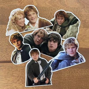 May include: A set of eight stickers featuring different images of a character from the Lord of the Rings movie franchise. The stickers are printed on white paper and have a rounded shape.