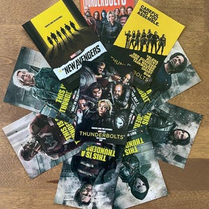 May include: A collection of promotional cards and a booklet for the Marvel Studios film, Thunderbolts. The cards feature character images and the text "Careful Who You Assemble." The booklet has the text "Everyone Deserves a Second Shot."