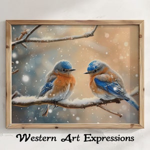 May include: A framed print featuring two bluebirds perched on a snow-covered branch. The birds have blue heads and wings, with orange chests. The artwork is set against a soft, blurred background with falling snow. The frame is made of light-colored wood. The text "Western Art Expressions" is at the bottom.