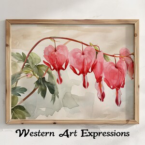 Op de afbeelding: Een aquarel schilderij van roze hartbloemen met groene bladeren op een lichtbruine achtergrond. Het schilderij is ingelijst in een licht houten lijst.