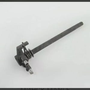 May include: A dark gray metal mechanical component with a long, rectangular shaft and a complex assembly of springs and levers. The component appears to be a gear or part of a larger machine.