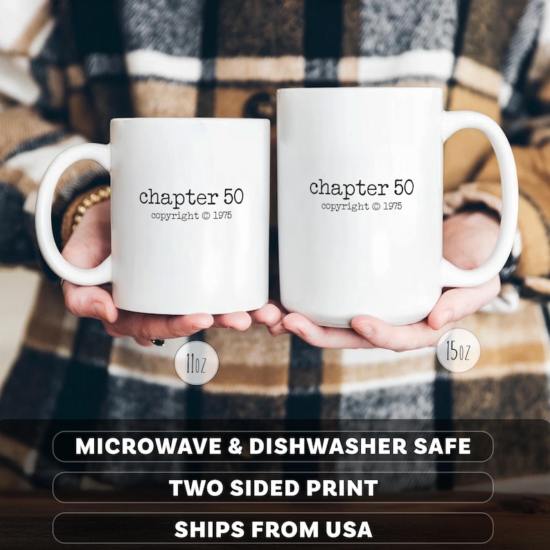 May include: Two white ceramic mugs, one 11oz and one 15oz, each with the text "chapter 50 copyright &copy; 1975" printed in black. The mugs have large handles and are held against a plaid background. The mugs are microwave and dishwasher safe.