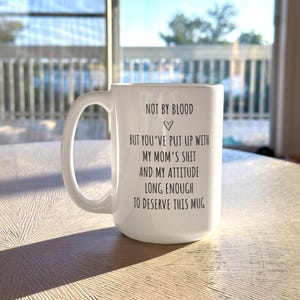 May include: A set of three ceramic mugs with a speckled, matte finish. Each mug features a different color: light blue, cream, and gray. The mugs have a simple, modern design and a comfortable handle.
