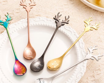 May include: Five colorful spoons with reindeer head handles. Each spoon has a different inscription: "Love", "Forever", "My Queen", "My King", and "Best Friend".