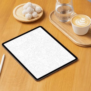 May include: A digital tablet with a white screen and a white stylus on a wooden table. A small wooden tray holds a glass of water and a cup of coffee. A small wooden plate holds several white, round treats.