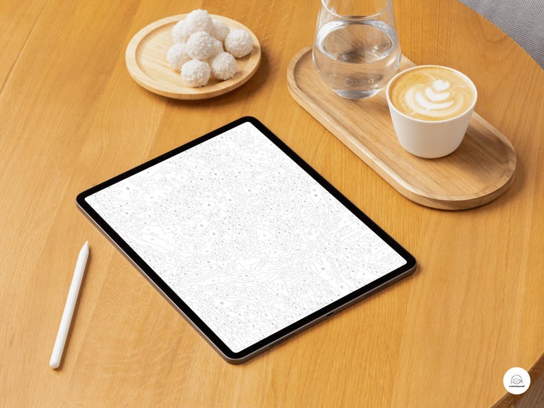 May include: A digital tablet with a white screen and a white stylus on a wooden table. A small wooden tray holds a glass of water and a cup of coffee. A small wooden plate holds several white, round treats.