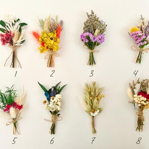May include: Eight small bouquets of dried flowers, each tied with twine and numbered 1 through 8. The bouquets feature a variety of colors and textures, including pink, purple, yellow, white, and red.