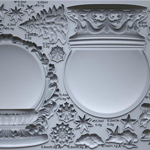 May include: A gray silicone mold featuring various designs for snow globes. The mold includes detailed shapes of trees, stars, snowflakes, and woodland creatures. The text "SNOW GLOBES IOD" is visible. Measurements are included.