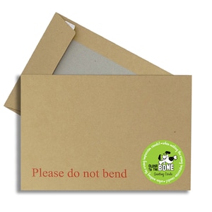 May include: A brown cardboard envelope with the text "Please do not bend" in red. A green circular sticker with a dog illustration and the text "CLOSE TO THE BONE Greeting Cards" is on the envelope.