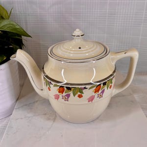 May include: A set of three ceramic mugs with a speckled, matte finish. The mugs are in shades of cream, light gray, and dark gray. Each mug has a simple, minimalist design, perfect for coffee or tea.