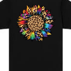 May include: A black t-shirt featuring a colourful sunflower design. The sunflower has a leopard print centre and rainbow-coloured petals.
