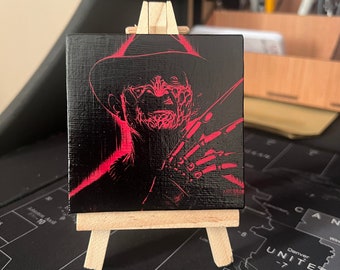 miniature canvas and easel painting with Freddy Kruger inspired design 75x75mm