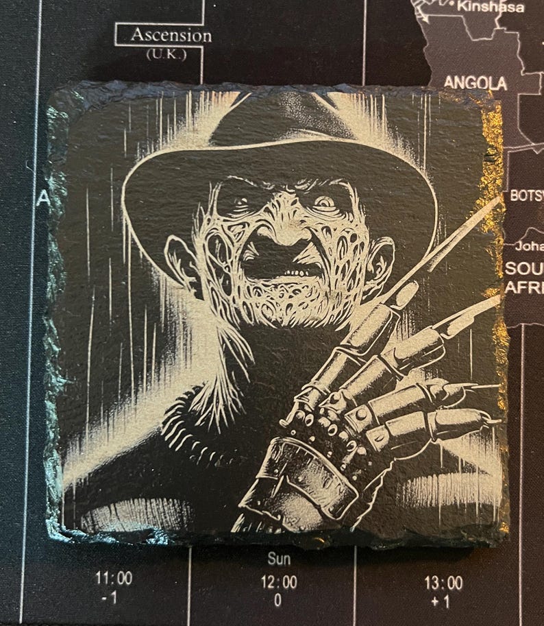 May include: Black and white illustration of Freddy Krueger, a horror movie character, with a striped background. He is wearing a brown fedora hat and a glove with blades.