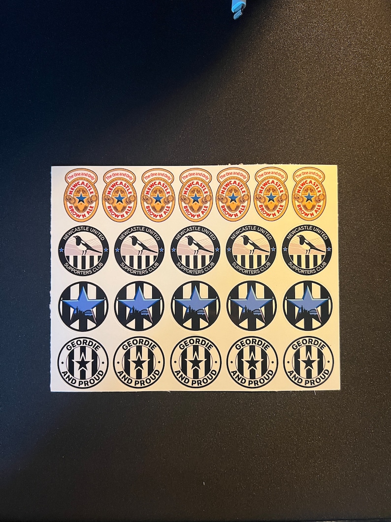 May include: A sheet of stickers featuring Newcastle United Football Club logos. The stickers feature the team's colors of black and white, with a blue star and the text "Newcastle United Supporters Club". Other stickers feature the text "The One and Only" and "Geordie and Proud".