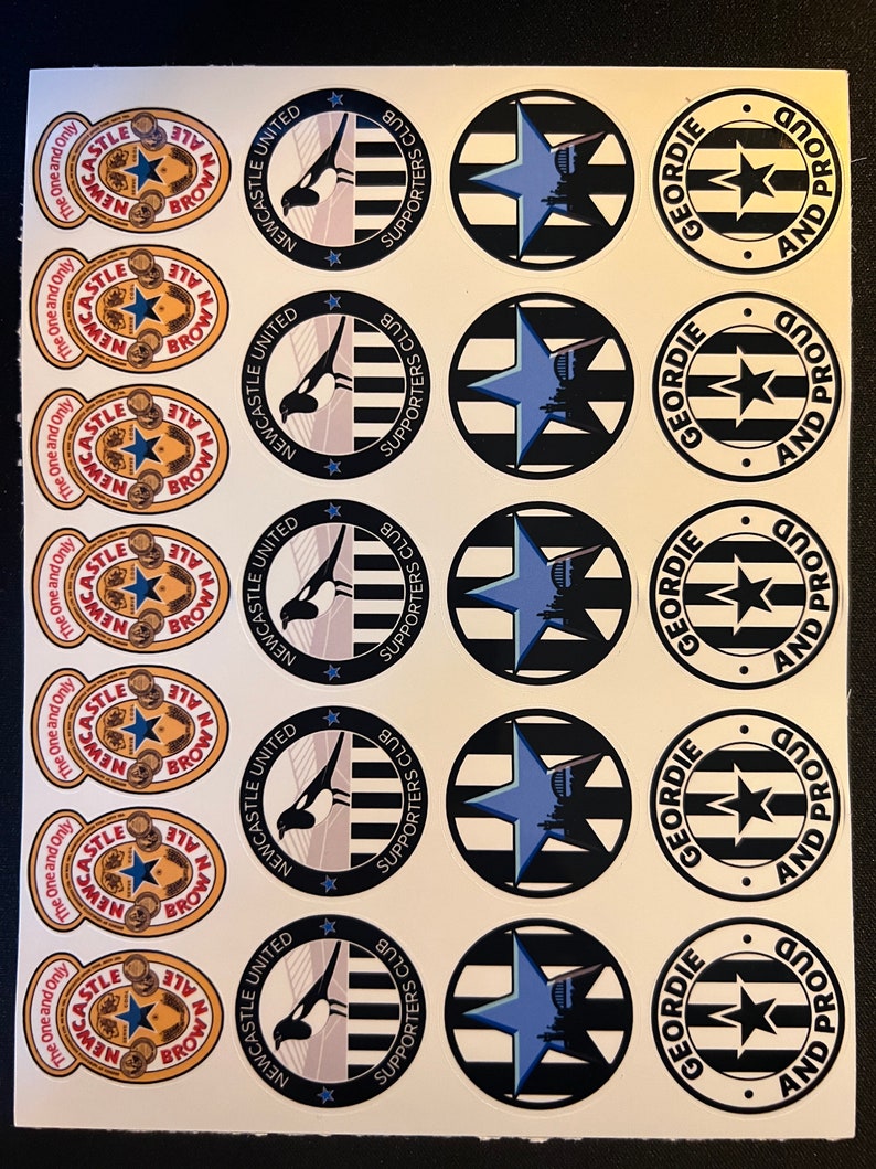 May include: A sheet of stickers featuring Newcastle United and Geordie football club logos. The stickers are black, white, and blue with a star and magpie design. The text on the stickers reads "Newcastle United Supporters Club" and "Geordie And Proud".