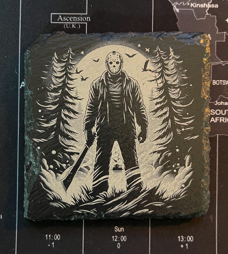 May include: Black and white illustration of a horror movie character holding a machete in a dark forest setting. The character is wearing a hockey mask and has a menacing expression.