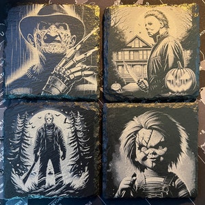 May include: Set of four black slate coasters featuring horror movie characters. The coasters feature Freddy Krueger, Michael Myers, Jason Voorhees, and Chucky. Each coaster has a white silhouette of the character against a black background.