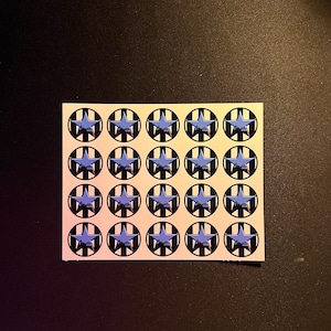 May include: A sheet of 16 round stickers with a black and white striped background and a blue star in the center.