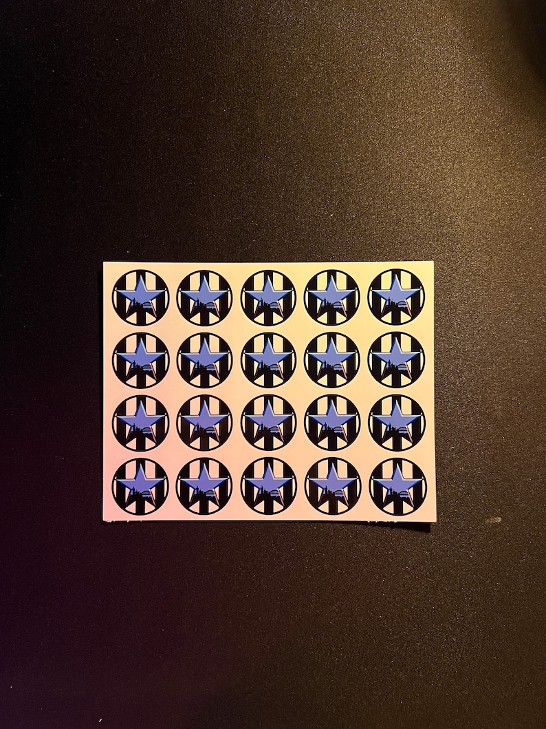 May include: A sheet of 16 round stickers with a black and white striped background and a blue star in the center.