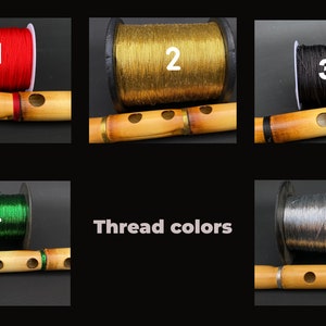 May include: An image showcasing five different spools of thread in red, gold, black, green, and gray, each paired with a bamboo flute. The text "Thread colors" is also present.
