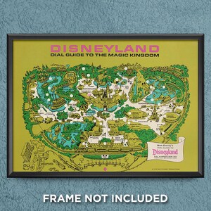 May include: A framed vintage Disneyland map print. The map is a detailed illustration of the park, featuring various lands and attractions. The print has a yellow background with green and white details, and the text "DISNEYLAND" is at the top.