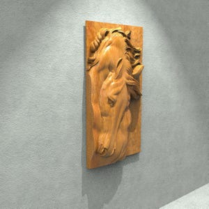 May include: A wooden wall sculpture of two horse heads, carved in a realistic style. The sculpture is mounted on a rectangular wooden plaque.