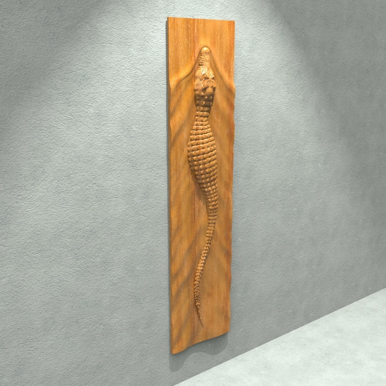 May include: A wooden wall sculpture of an alligator with a textured, scaly design. The alligator is carved in relief and appears to be emerging from the wood.