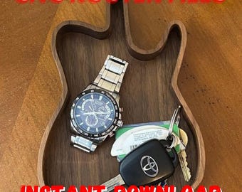 May include: A wooden tray shaped like a guitar, with a watch, keys, and a key fob inside. The tray is made of dark wood and has a natural finish. The text "CNC ROUTER FILES INSTANT DOWNLOAD" is printed in red on the bottom of the tray.