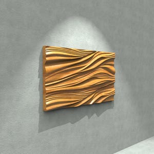 May include: A rectangular wooden wall art piece with a wave-like pattern carved into its surface. The artwork is a warm, natural wood tone, mounted on a gray wall. The piece is illuminated by a spotlight, creating shadows that emphasize the texture.