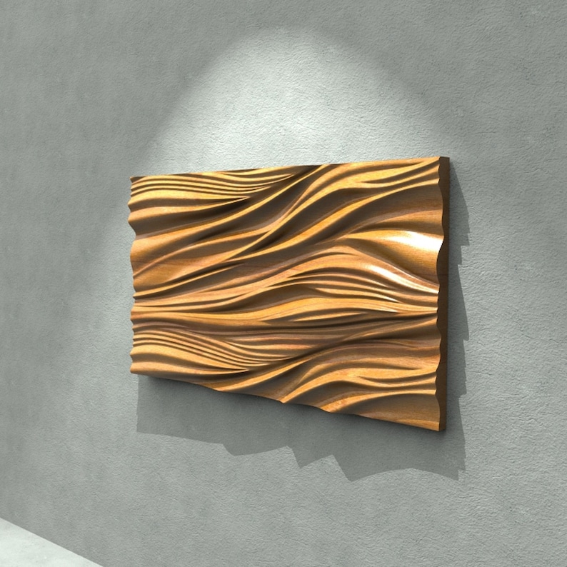 May include: A rectangular wooden wall art piece with a flowing, wave-like design. The artwork is made of light brown wood and is mounted on a gray wall. The piece is approximately 30 inches wide and 20 inches tall.