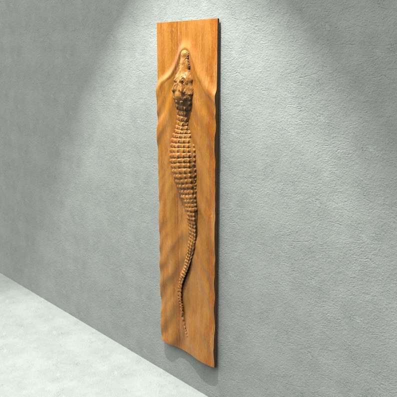 May include: A wooden wall sculpture of an alligator carved in relief. The alligator is brown and has a textured surface. The sculpture is mounted on a wooden panel.
