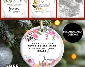 May include: A collection of round ceramic ornaments with floral designs and text. One ornament reads "Mom, Thank you for trusting me with a piece of your heart." Other ornaments have text for weddings. The ornaments are white with a string for hanging.
