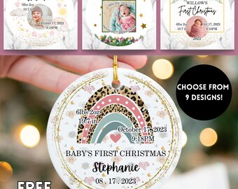 May include: A white ceramic Christmas ornament with a gold rim, featuring a rainbow design and the text "BABY'S FIRST CHRISTMAS." Includes baby's name, birth date, weight (6lbs 2oz), and length (19.7 in). The image also shows other ornament designs.