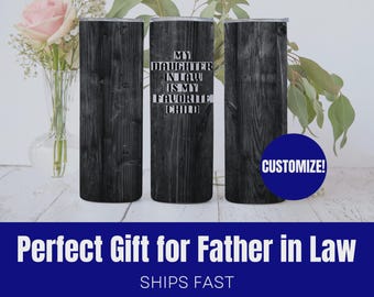 May include: A set of three black wooden-look tumblers. One tumbler has the text "MY DAUGHTER IN LAW IS MY FAVORITE CHILD" in white. A blue circle with the word "CUSTOMIZE!" is on the right. The bottom of the image has the text "Perfect Gift for Father in Law".